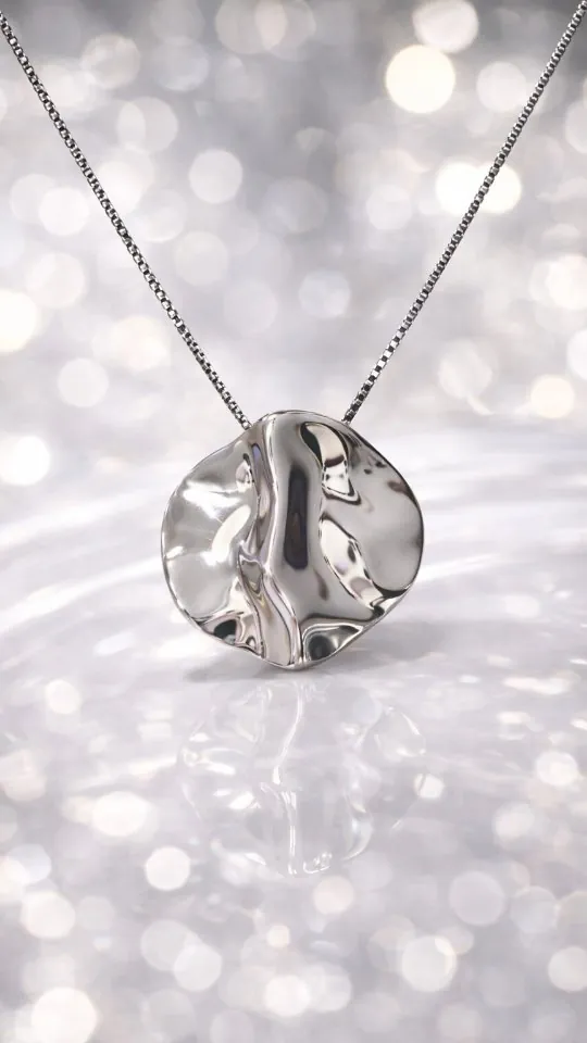 Hammered silver disc pendant on a fine chain