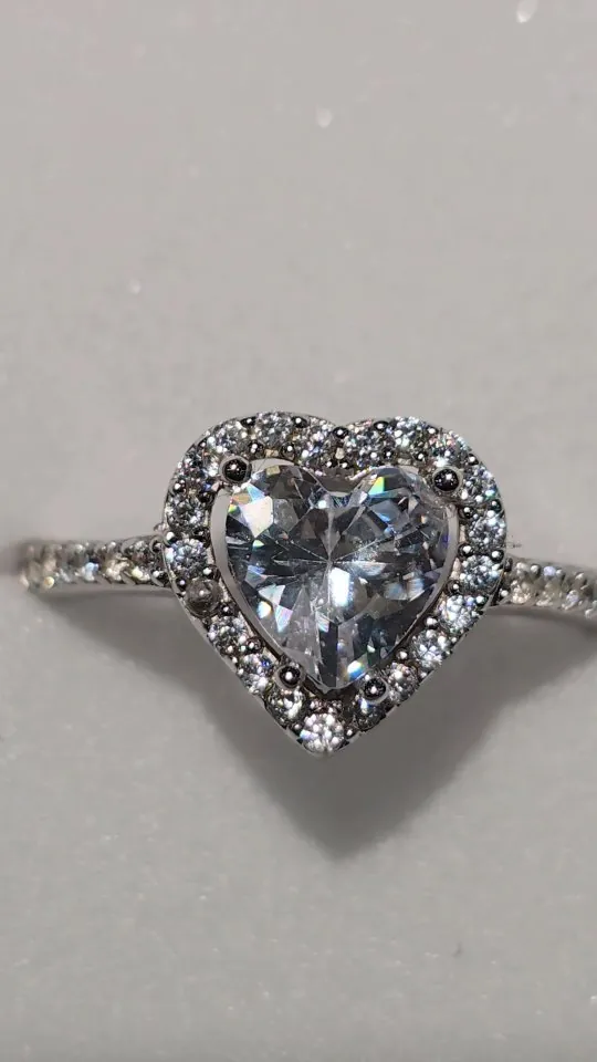 Silver heart ring with a halo of clear stones