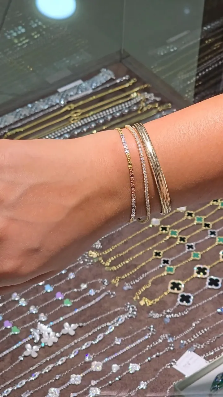 Stack of thin silver bracelets on a wrist