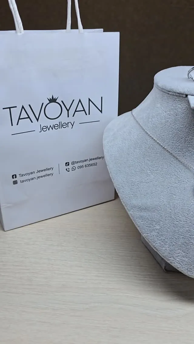 Tavoyan Jewellery gift bag next to a necklace display